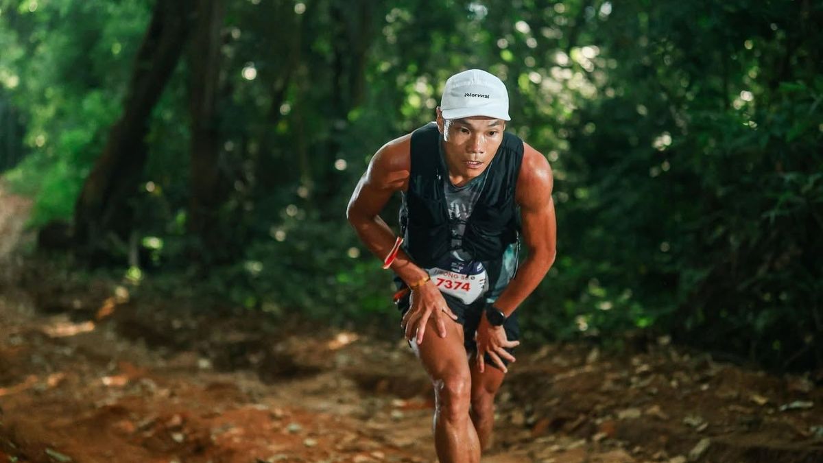 NNormal athlete racing up a forest trail
